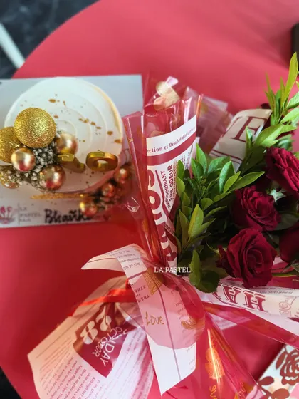 A classic gift combo featuring a white and gold cake and a bouquet of red roses. Perfect for anniversaries or birthdays.
