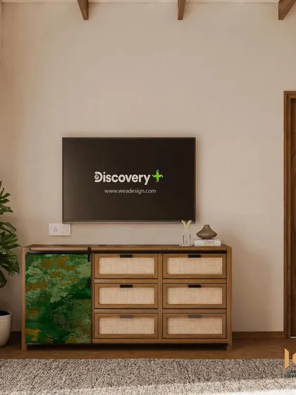 A full view of the custom TV console, showing the blend of natural wood, cane, and the bold green accent piece.