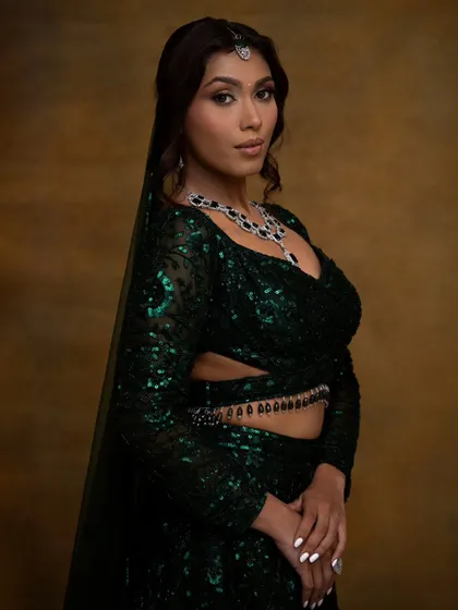 This side profile highlights the modern silhouette of the lehenga and the elegant hairstyle. The makeup remains flawless from every angle, ensuring you look perfect in all your photos.