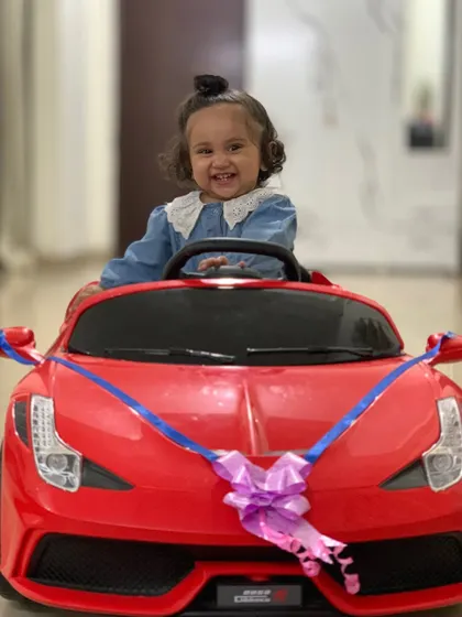 My daughter is ready to drift in her new toy car. Her happy and excited face is priceless.