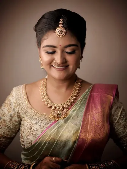 A joyful, smiling portrait. The makeup enhances her happiness, with a radiant finish that lights up her face.