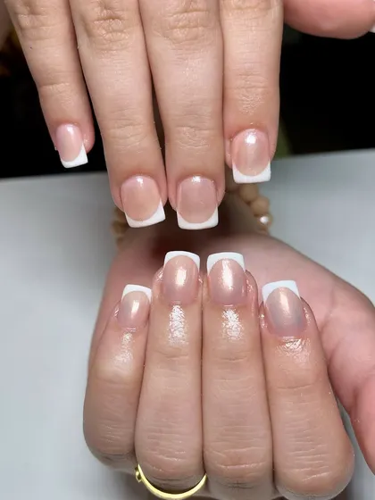 Another example of a chrome and French combination. The pearlescent chrome base gives the traditional white tip a luminous, almost ethereal glow.