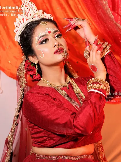 Another angle of the Bengali bridal look, emphasizing the dramatic eye makeup and the traditional red bindi with the classic hairstyle.