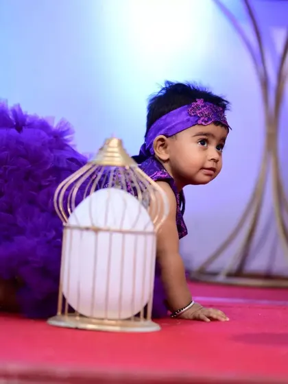 The purple ruffled dress in action. The design is not only beautiful but also durable enough for an active toddler to explore and play during her celebration.