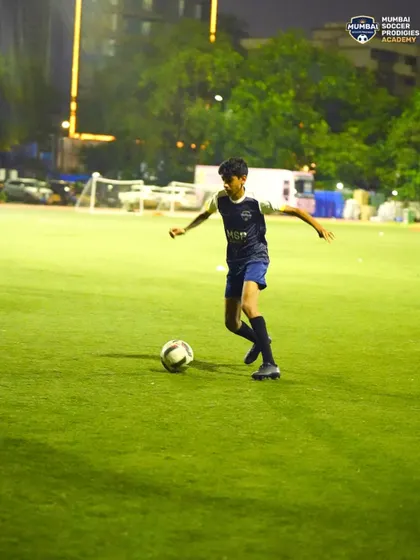 A player scans the field, demonstrating awareness and vision while in possession of the ball.