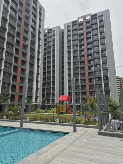 The swimming pool and podium area at Adani Amogha in Ahmedabad. We designed these amenity spaces to be an urban oasis, providing residents with a refreshing escape surrounded by thoughtful landscaping.
