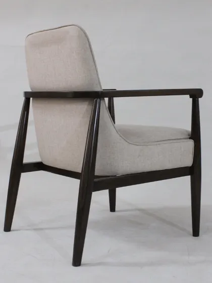 The side profile of the mid-century chair highlights its ergonomic design and classic silhouette.