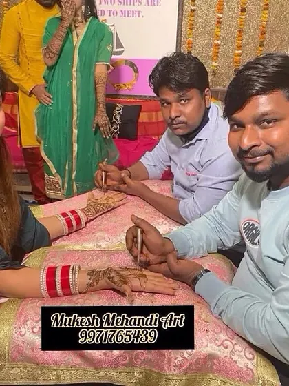 Me and my team member working together on a client's hands. We often work in pairs for bridal mehandi to ensure the design is completed in good time.