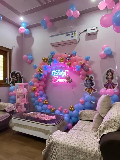 A view of the Kanha ji baby shower setup from the side, highlighting the depth and dimension of the balloon decorations.