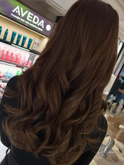 This client was ready for a big change, so we went from long to mid-length hair. I added fringe bangs and a color refresh to complete her stylish new look.