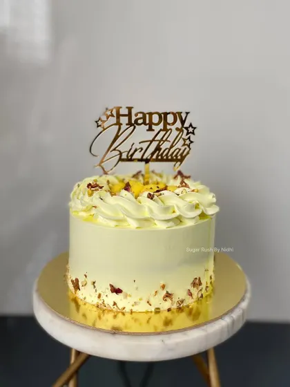A beautiful Rasmalai cake, one of my most popular fusion flavors. It's decorated with pieces of rasmalai and chopped nuts for an authentic taste.