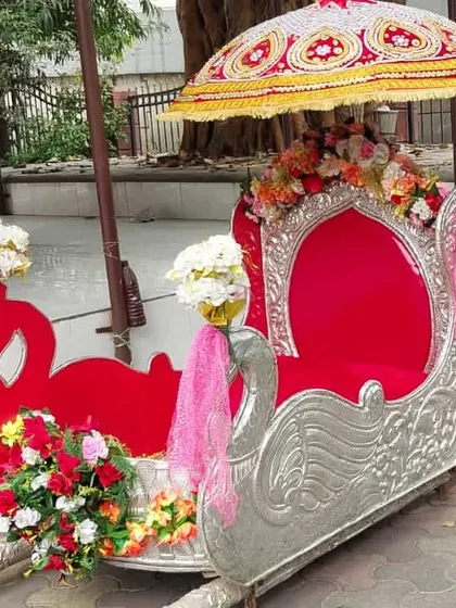 A beautiful swan-themed silver and red Palki available for rent. This open-style Doli is perfect for ensuring the bride is visible and gets amazing photos during her entrance.