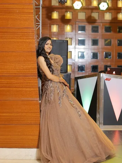 A client looking stunning and having fun in a brown tulle gown. The embroidered details on the bodice catch the light beautifully, making it perfect for an evening event.