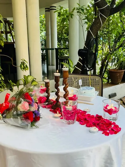 Another view of the romantic dining setup, perfect for an anniversary or a special date. The outdoor garden setting adds to the charm.