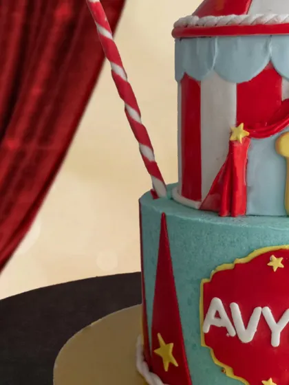 A detailed shot of the circus tent cake, showing the striped patterns and star decorations.