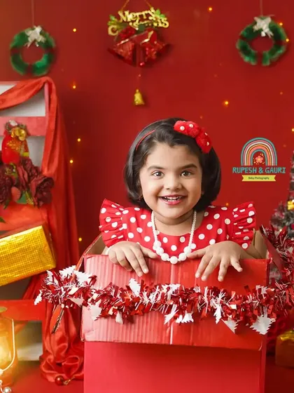 Peek-a-boo from a Christmas present. We love capturing these playful and joyful moments.