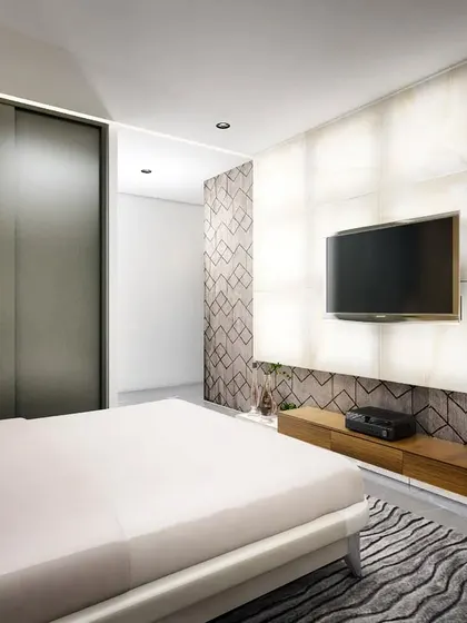 For this bedroom, the client wanted a feature wall that was a piece of art in itself. We designed a backlit onyx wall that serves as a luminous, dramatic backdrop for the television, transforming the space and providing a beautiful focal point even when the screen is off.