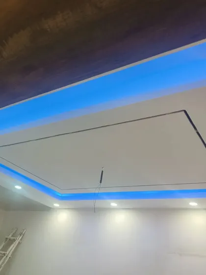 The same ceiling design with the blue lighting, showing how it contrasts with the warm white spotlights.