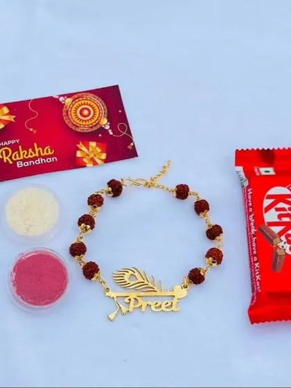 A simple and sweet Rakhi gift set, including a personalized rudraksh bracelet, a KitKat, and roli-chawal.