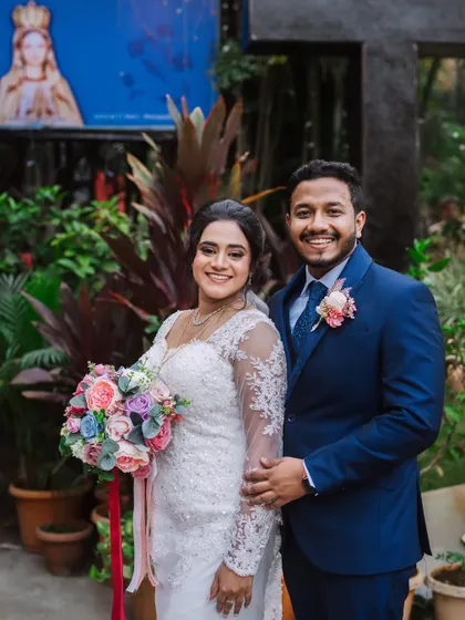 A lovely outdoor portrait of the newly married couple. The bride's elegant gown and the groom's sharp suit look perfect together.