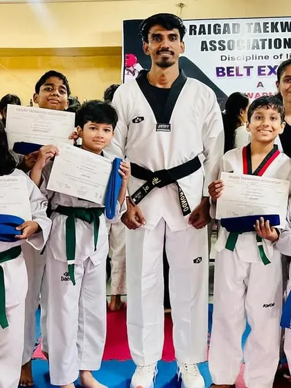 A group of my students proudly holding their certificates and awards after a belt exam.