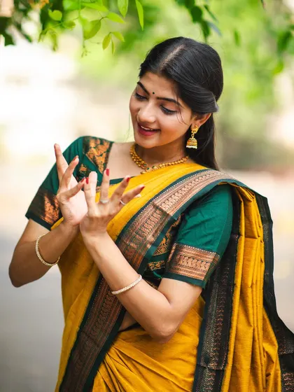 Another look from the 'Manjal' saree photoshoot. The focus here is on the expressive face and hand mudras, central to the storytelling aspect of Indian classical dance.