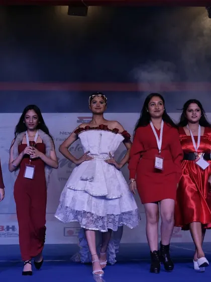 A group of student designers and their models walk the finale of their collection showcase.