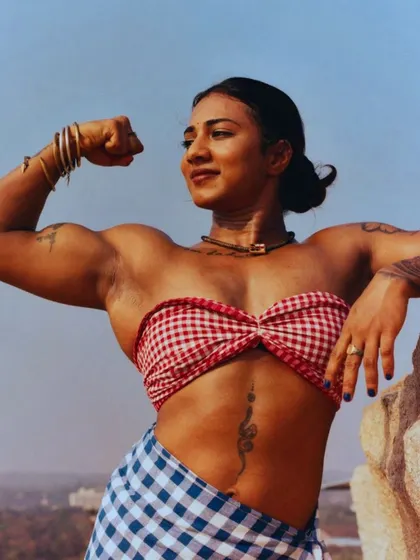 Happy Kannada Rajyotsava. Celebrating my heritage with a powerful bicep flex in a traditional lungi and top, set against the rocky landscape of Karnataka.