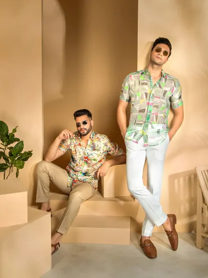 This shot uses varied levels and poses to create a dynamic composition for the menswear shoot. It effectively displays the full outfits, from the printed shirts to the choice of footwear.