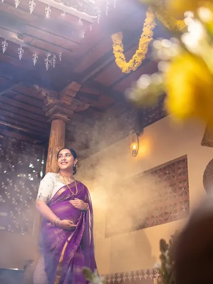 A dreamy, atmospheric shot using natural light and a touch of haze to create a cinematic and emotional portrait of an expectant mother.