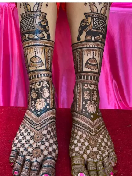 A heavy bridal foot design with elephant motifs and jhumka (earring) patterns, ensuring the bride's feet are as beautifully adorned as her hands.