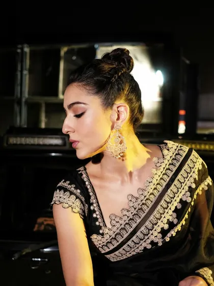 The bright and shining Sara Ali Khan wearing handcrafted 18k gold Chandbali earrings. These statement pieces are detailed with natural diamonds and pearls for a classic festive look.