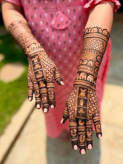 A special baby shower mehendi for a mother and her young daughter, featuring matching elements like tiny elephants, cradles, and toys to include the whole family in the celebration.