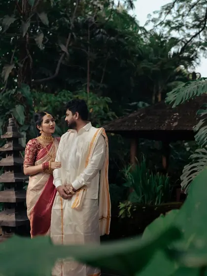 A series of photos from a post-wedding shoot in a lush, tropical garden. The couple's traditional attire looks stunning against the vibrant greenery.