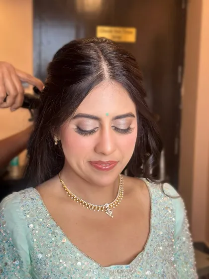 A close-up of the soft glam makeup. I used a silver-toned shimmer on the eyes to match her pastel blue lehenga, creating a look that is ethereal and elegant.