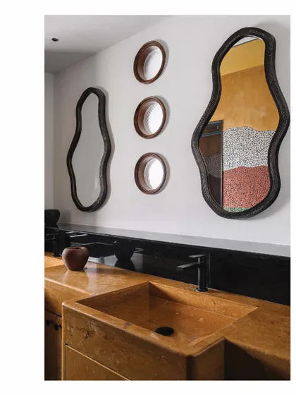 In this master bathroom, the walls themselves become art. We created a Van Gogh-inspired china mosaic wall, a colorful and textured masterpiece. The custom Jaisalmer stone basin and counter add to the earthy, artistic feel of the space.