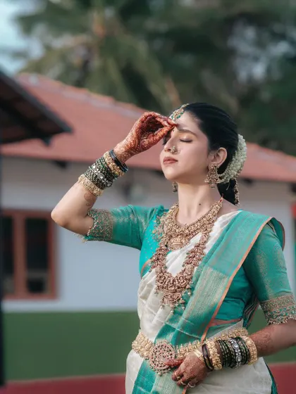 A serene and beautiful portrait of the bride, her eyes closed in a moment of quiet reflection amidst the wedding day festivities.
