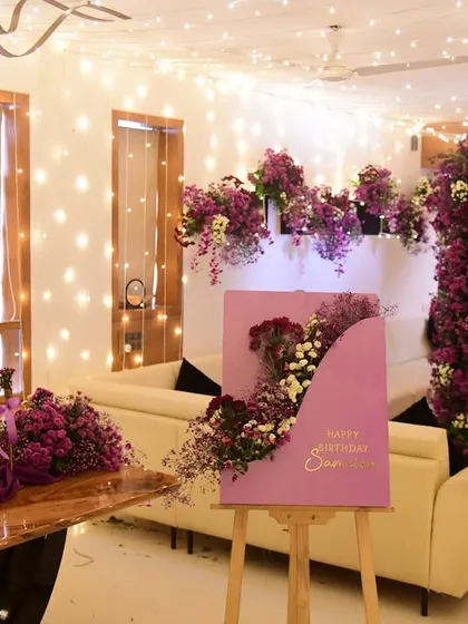 The complete party setup, ready for guests. The combination of lush florals and a canopy of fairy lights makes the space feel truly magical.