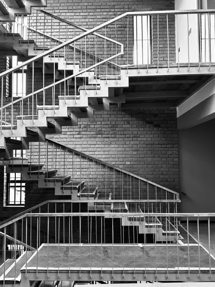 Work-in-progress photos from another residence in Thrissur, showing the raw beauty of the structure with its curved brick walls and complex interior staircases.