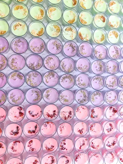 Rows of votive candles with botanical toppings, a stunning visual of a large, colorful Diwali order.