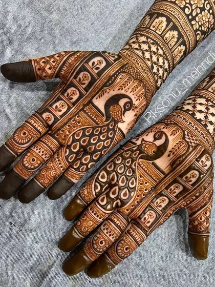 Graceful peacocks are the centerpiece of this elegant engagement mehndi. The fine lines and detailed feather work create a sense of movement and beauty, perfect for a bride-to-be.