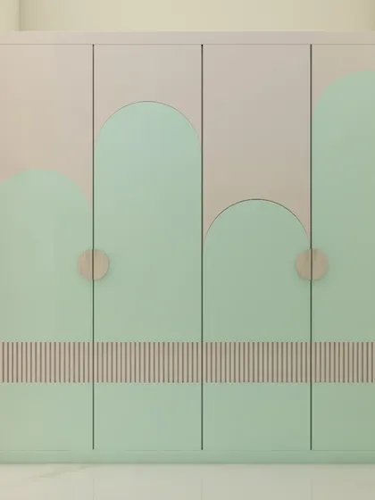 A playful yet stylish wardrobe design for a kid's room, featuring mint green doors with curved, cloud-like patterns. This custom piece adds a touch of whimsy while providing practical storage.