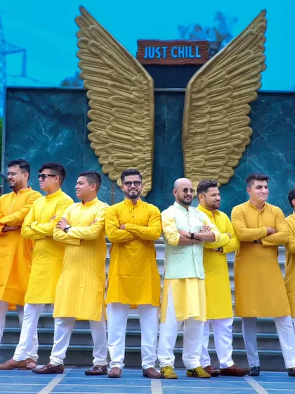 A full-length shot of the groom and his groomsmen, showcasing their coordinated Haldi outfits and their strong bond.