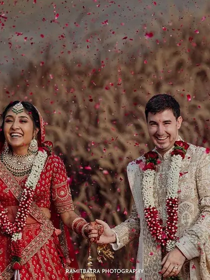 A moment of pure joy as the couple is showered with flower petals after their ceremony at Alila Fort Bishangarh.