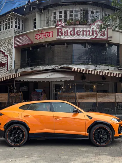 The striking orange of a Lamborghini against the classic facade of our Bandra outlet.