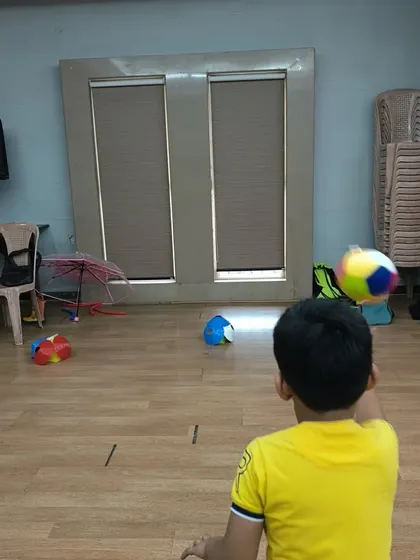 Another great shot of our indoor ball-throwing activity. This simple game is perfect for practicing aiming and throwing, which are key components of many sports.