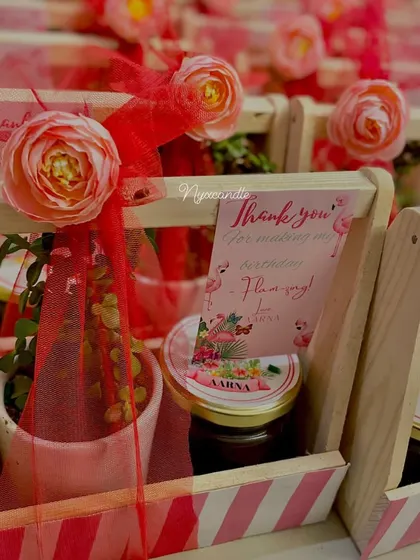 Another angle of the flamingo-themed first birthday favors, highlighting the beautiful floral and net wrapping.