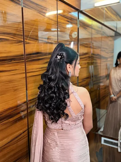 Another view of the elegant high ponytail, showing the delicate, sparkling hair accessory that adds a touch of glamour.