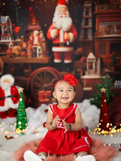 Celebrating a first Christmas is a special milestone. This little girl's happy smile shows the magic of the season.