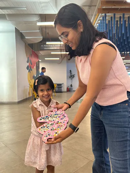 A little artist receiving her finished masterpiece at our pop-up art station. Her joy is contagious.